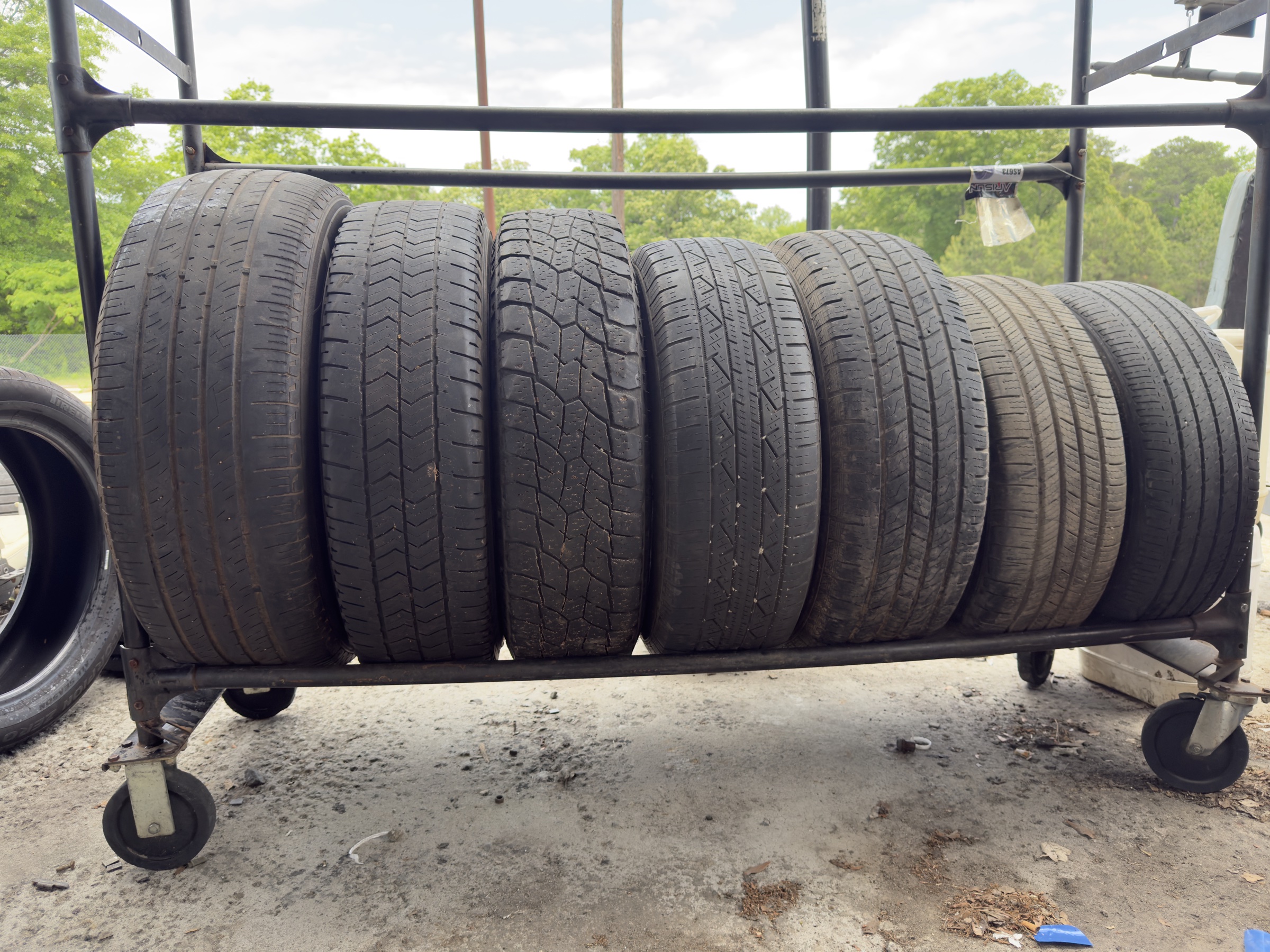 Used tires lined up on the MTS tire rack in Conyers